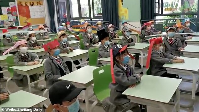 A clip from Sunday shows a group of children sitting in their classroom while wearing their hand-made devices at the Yangzheng Primary School in the Chinese eastern city Hangzhou