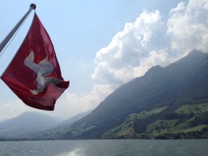 Swiss Flag Waving In Mountain Range